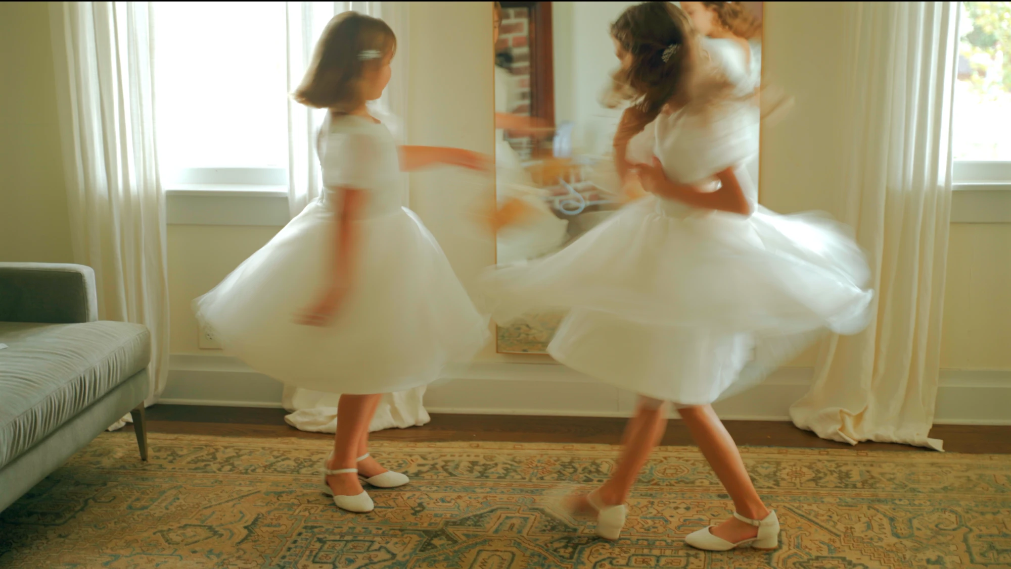 Flower girls twirling in white dresses