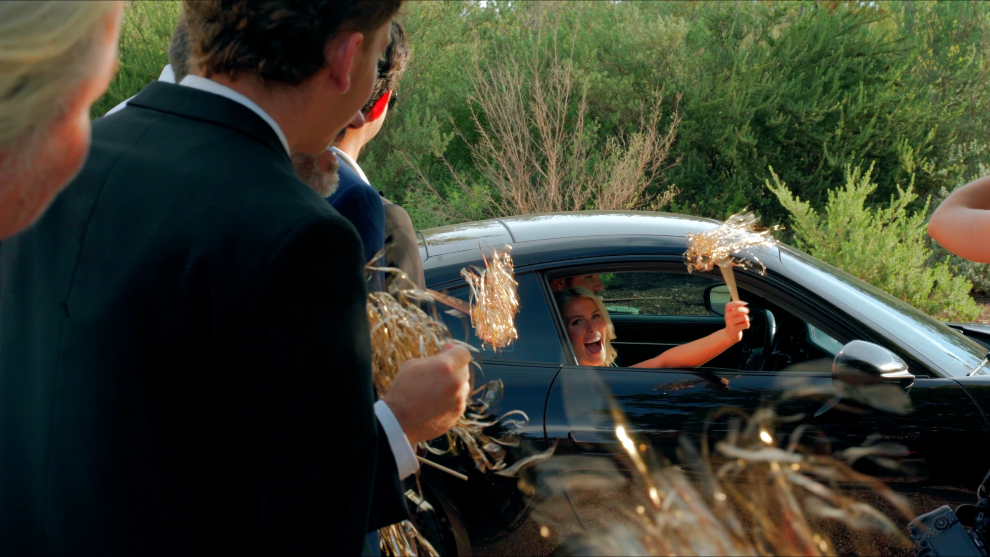 Bride waving from the getaway car